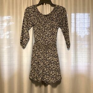 Black with daisies Hollister romper in size Extra Small.